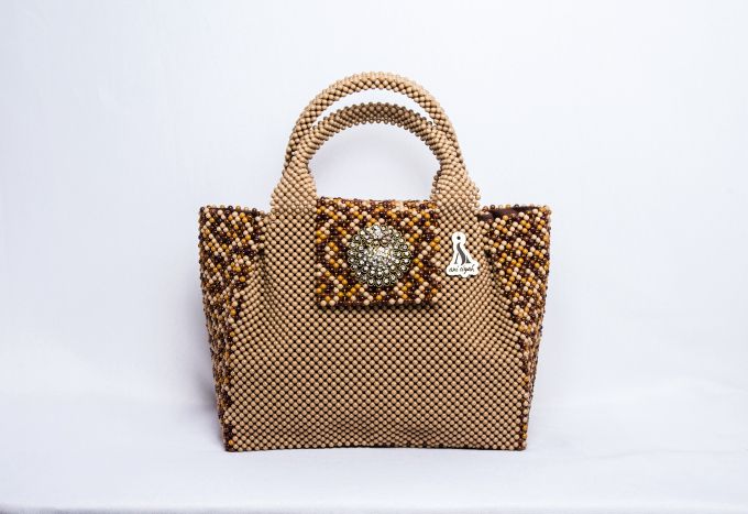 A neutral purse in different shades of brown and gold embellished with a touch of silver exudes effortless glamour. 