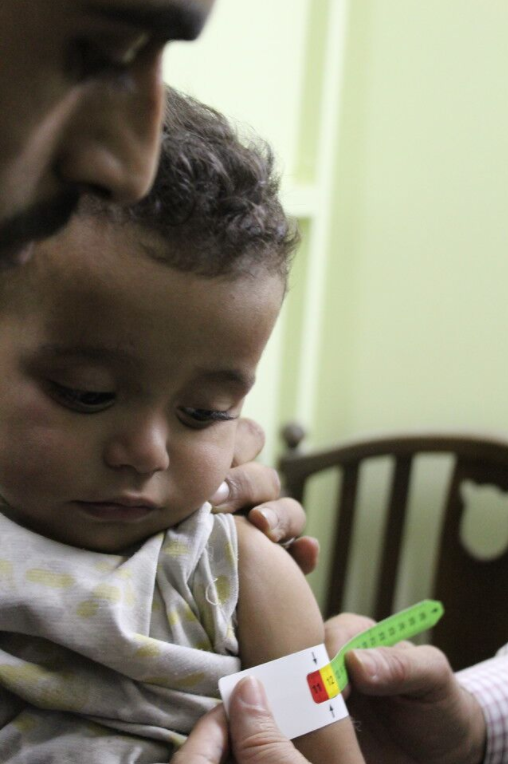 A child is screened for malnutrition at Al Kahef hospital in Kafr Batna