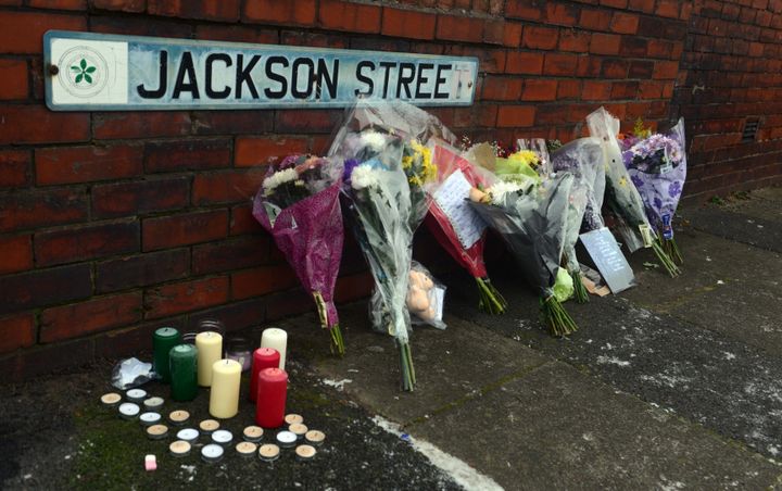 Neighbours and friends have been leaving floral tributes and candles near the family home 