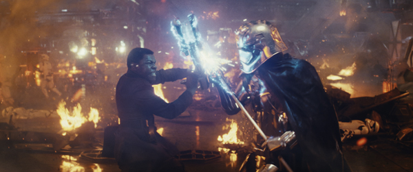 L to R: Finn (John Boyega) battling Captain Phasma (Gwendoline Christie)