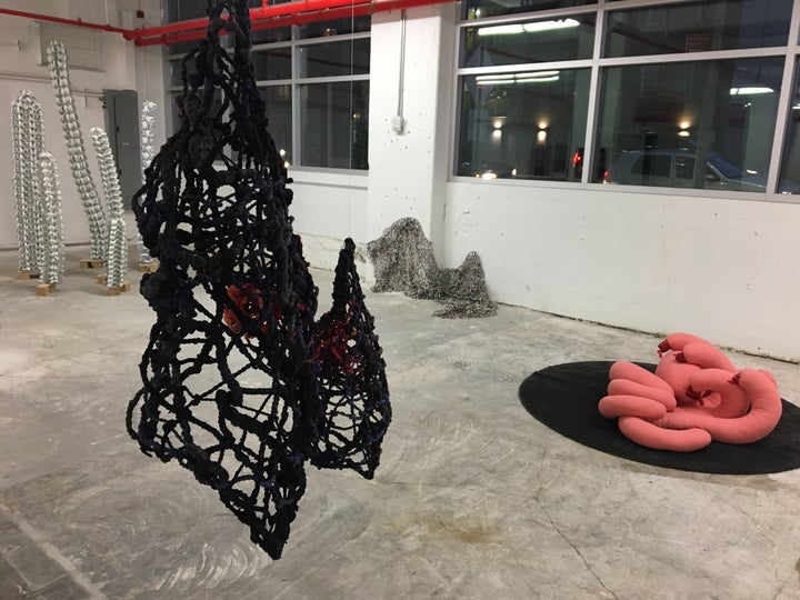 <p>Kate Rusek, <em>Blind Adjustments</em>, aluminum, vinyl, and hardware; Tomo Mori (hanging in foreground) <em>Warmth,</em> woven fabric and found objects<em>; </em>Kate Rusek, <em>Fashion Textile,</em> aluminum and vinyl; Luiza Kurzyna, <em>Cuddle Monster,</em> fabric, elastic, poly-fiber, rug (L—>R) <em>Intertwined</em> at 470 Vanderbilt Ave with Chashama</p>
