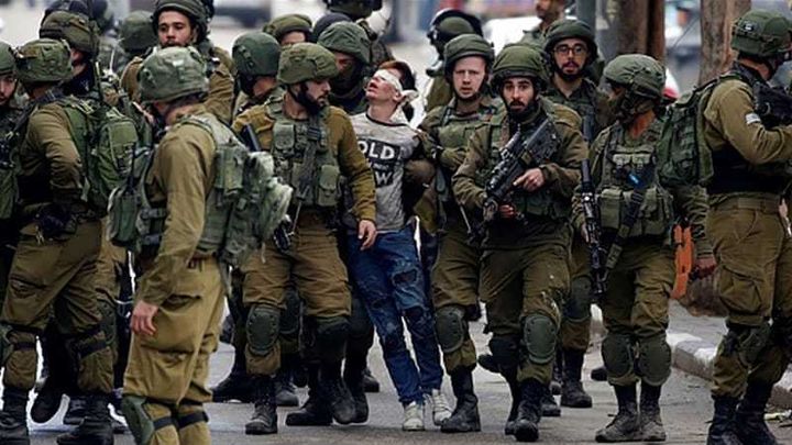 16-year-old Palestinian, Fawzi al-Junaidi, arrested by Israeli occupation forces.