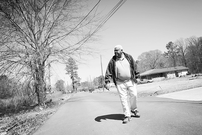Pastor Bouie walking on his street