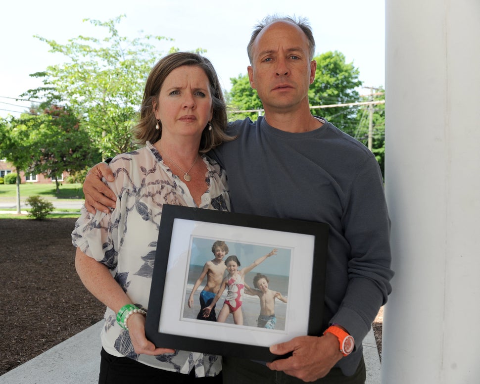 Mark Barden and his wife, Jackie, hold a photo of their children.