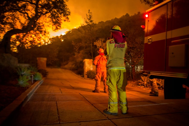 Firefighters watch flames as the Thomas fire approaches homes in Montecito, California on Dec. 12, 2017.