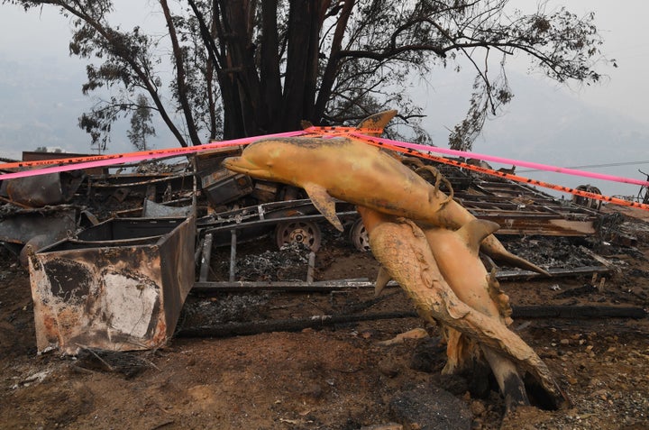 A dolphin statue is seen at a property destroyed by the Thomas fire in Carpintera, California, on Dec. 12, 2017.