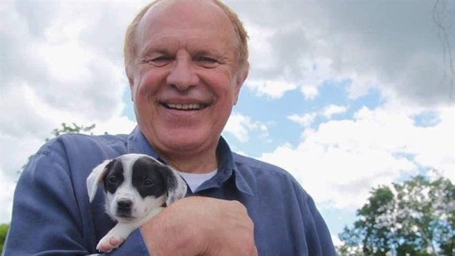 Democratic state Sen. Raymond Lesniak holds a rescue puppy at a “Paws Walk for a Cause” fundraiser in New Jersey. Lesniak is