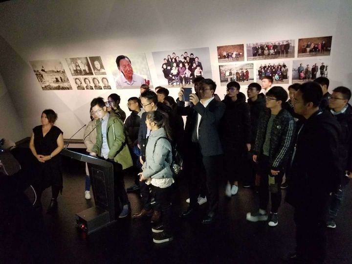 Students gather around as New Dimensions in Testimony Mandarin Project Assistant, Cheng Fang demonstrates interactive testimony, with creator and producer, Heather Maio-Smith, at the Nanjing Massacre Memorial 13 December 2017. 