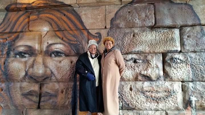 Volunteers in front of a mural by Chicago Public Art Group artists Rahmaan Statik Barnes and Max Sansing in the 22nd Ward on Chicago's Southwest Side funded through participatory budgeting. 