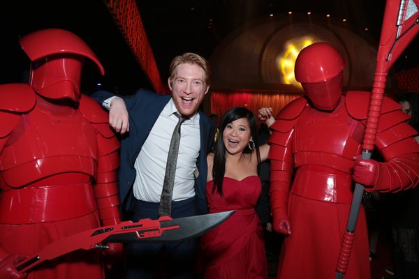 Domhnall Gleeson and Kelly Marie Tran pose with Praetorian guards at the after party for the world premiere of Star Wars: The Last Jedi 