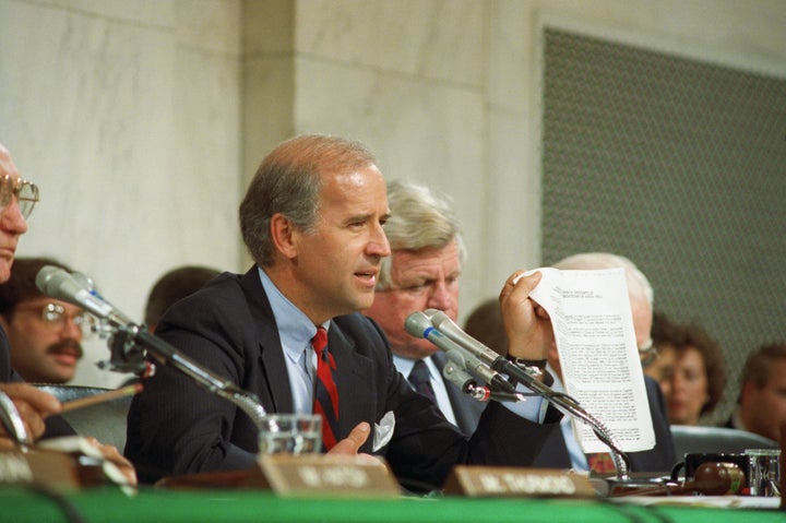 Biden holding up a copy of the FBI report on Hill during the 1991 committee hearings on Thomas. 