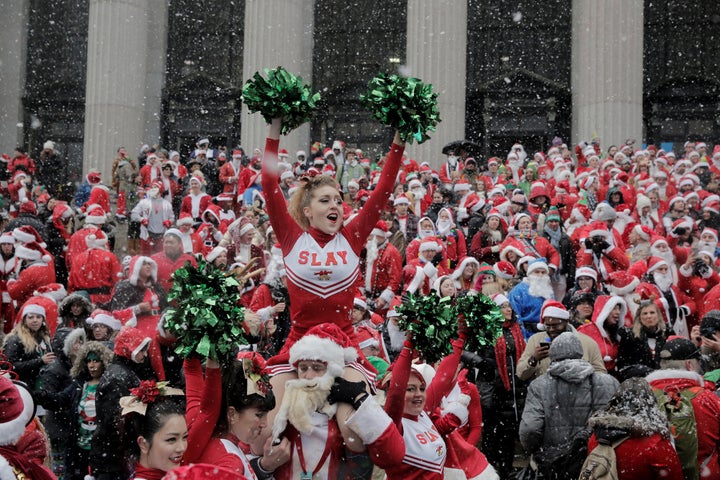 Revellers dressed as Santa Claus and in other holiday themed costumes celebrate during the annual SantaCon event in New York City, Dec. 9, 2017.