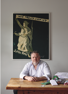 Chef Stephen Harris backed by his “I Hate French Cooking” poster by Jamie Reid, an artist who worked with the punk band the Sex Pistols