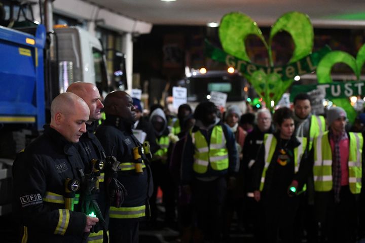 Members of the London Fire Brigade stand in a guard of hounour during a silent candlelit march to mark the six month anniversary of the Grenfell Tower fire. 