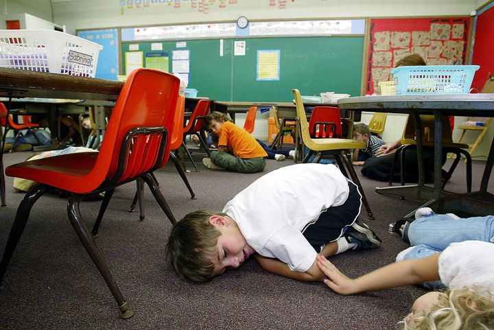 Kindergarten students in Hawaii lie on the floor during a classroom lockdown drill in 2003. 