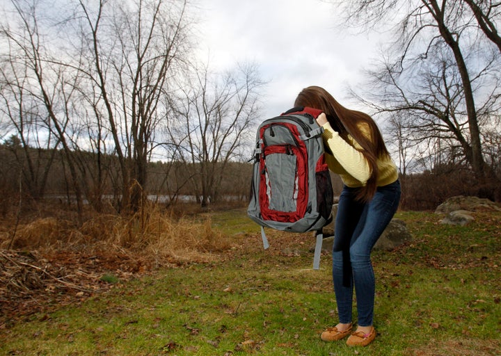 Amanda Curran, daughter of Bullet Blocker inventor Joe Curran, demonstrates how to use a child's bulletproof backpack in the