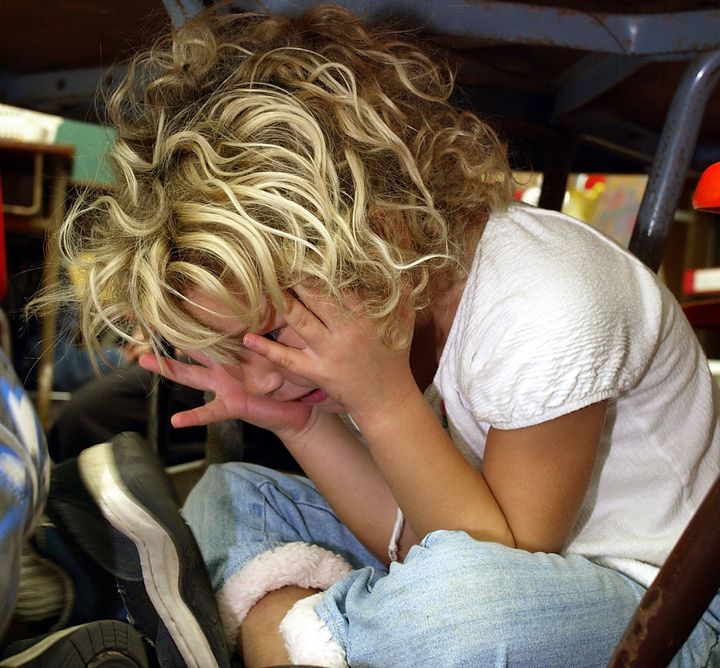 A kindergarten student during a lockdown drill in 2003. With increased school security comes concerns about the psychological toll on young people.