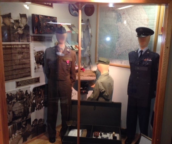 The entire exhibit, which also includes a radio operator and items such as an enlisted airman’s footlocker in between the Strang and Holcomb displays.