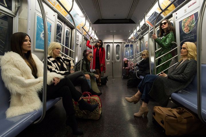 The cast on a subway train.
