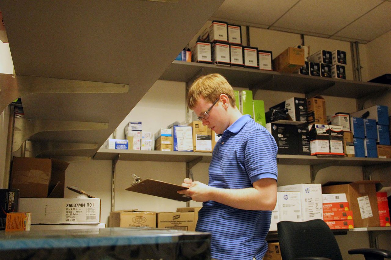 Peter O'Halloran checks supplies at his job. O'Halloran works full-time at a nonprofit in Philadelphia.