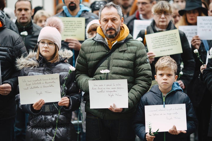 Sibiu, Romania. Silent protesters hold up sheets of paper with quotes from late King Michael’s speeches and texts. 