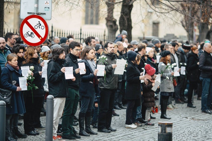 The protesters of Sibiu’s Vă vedem (“We See You”) anti-corruption movement, including Romanian poet and scholar Radu Vancu (center), hold a silent demonstration.