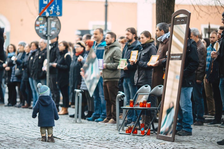 Silent protesters in the Anti-Corruption Zone of Sibiu hold mirrors that say “What do you see?”