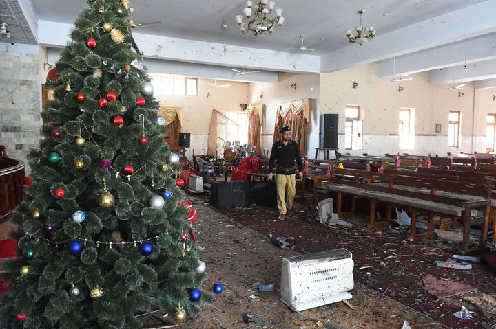 A Pakistani investigator collect evidence a day after a suicide attack in the Methodist Church in Quetta on December 18, 2017.