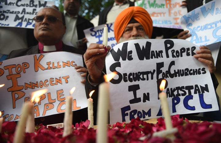 Protestors shout slogans against a suicide attack on a church during a protest in Karachi on December 18, 2017. 