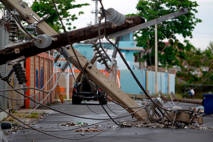 Powerline poles that were toppled by the Category 4 storm are seen in a San Juan street on Nov. 7, nearly two months after the storm made landfall.