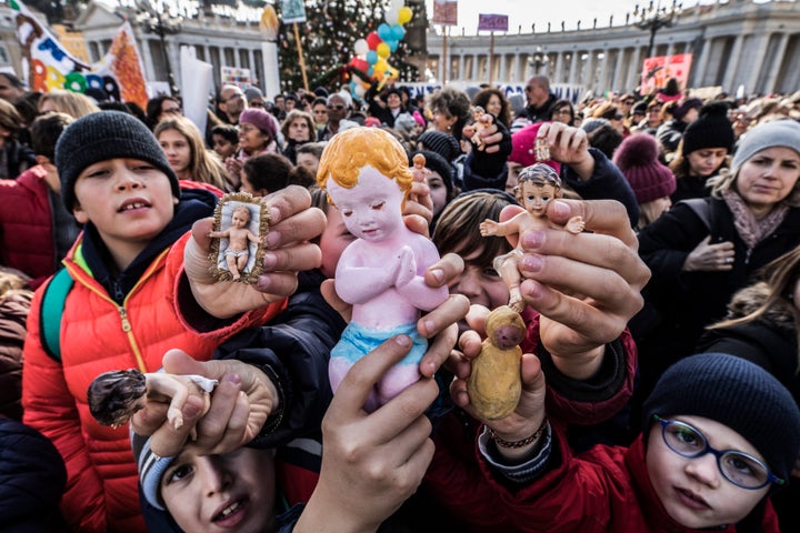 Following a custom started by the late Pope John Paul II, Pope Francis blessed Nativity figurines brought by pilgrims on Dec.