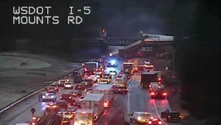 An Amtrak passenger train in seen derailed on a bridge in Washington State