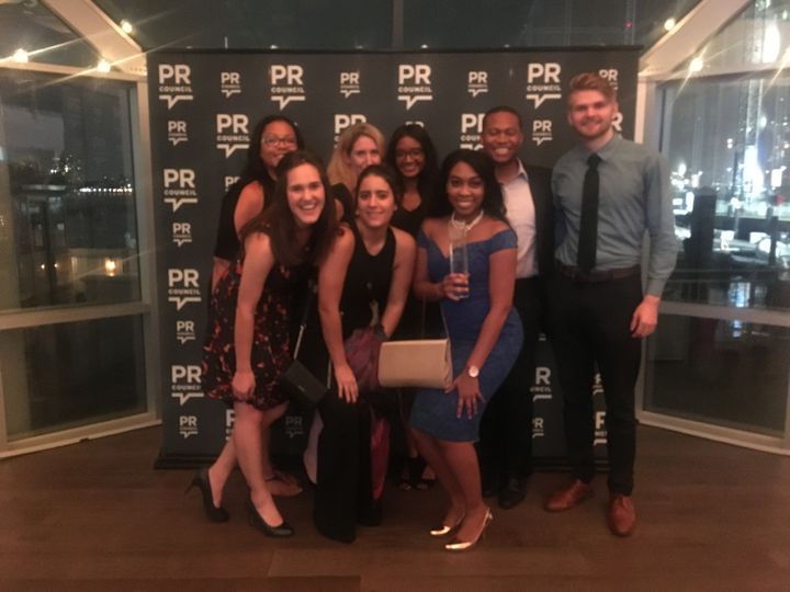 Ashley Simms poses with FleishmanHillard employees after receiving the Outstanding Young Professional Awards at the 2017 Diversity Distinction in PR Awards