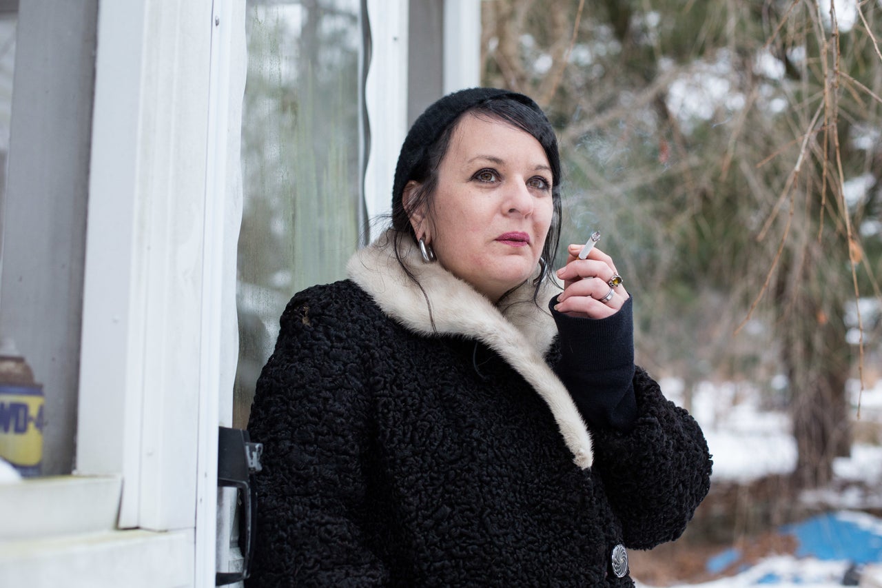 Jess Tilley, founder of the New England User's Union, smokes a cigarette outside her home.