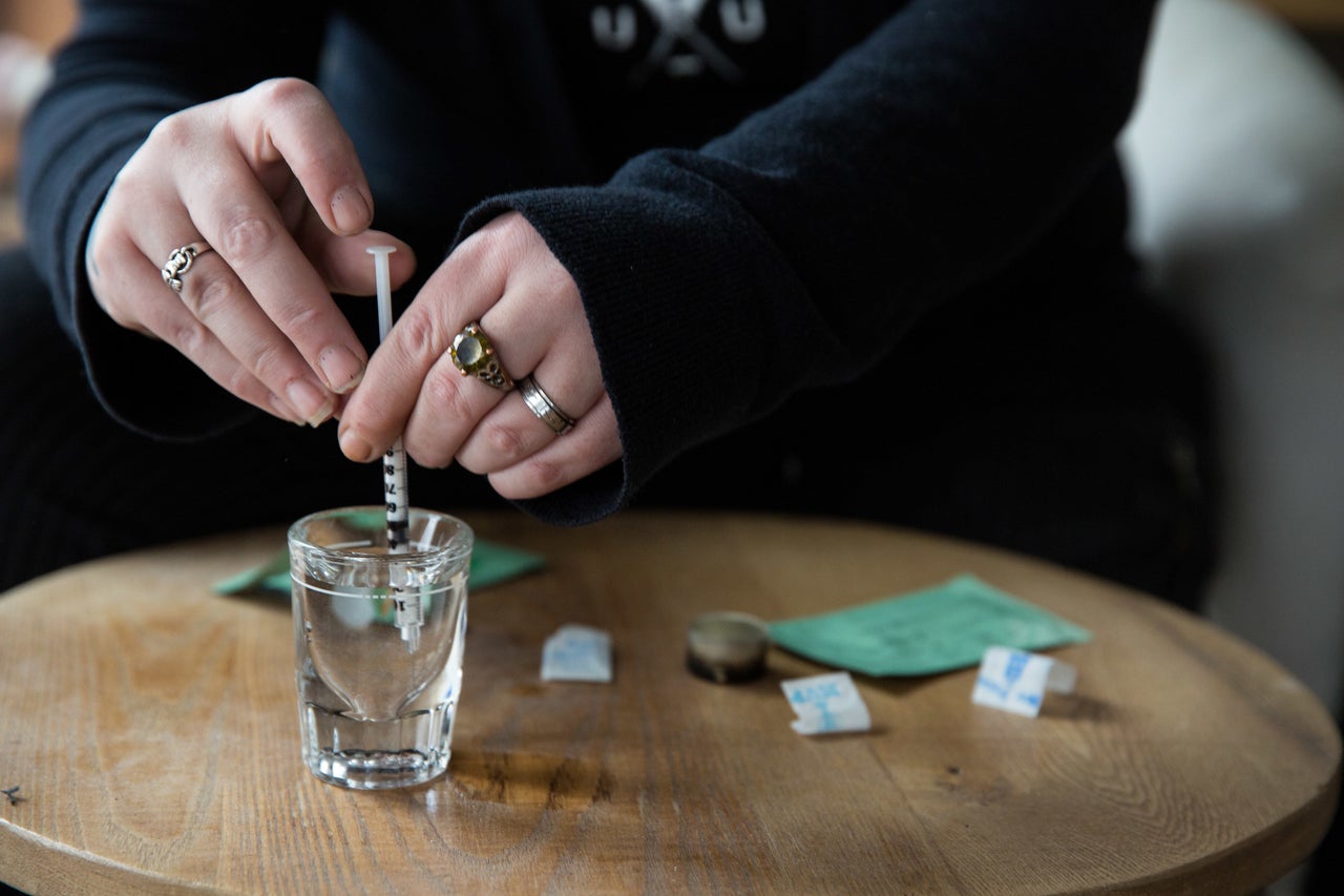 Tilley tests for the presence of Fentanyl by gathering drops of water and mixing them with the drugs. Then she will dip the test strip into the water.