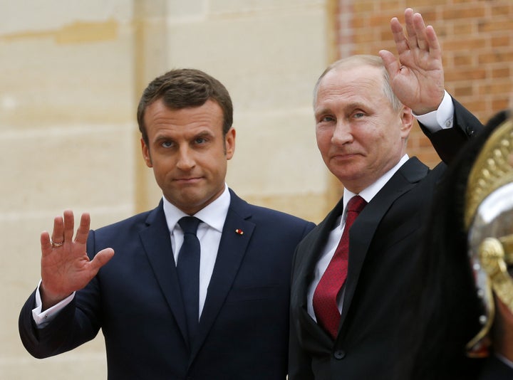 French President Emmanuel Macron, left, seen with Russian President Vladimir Putin in May, has criticized RT as a Russian pro