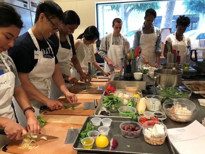 Graduate students participating in a cooking lesson class at Sur La Table in Westwood