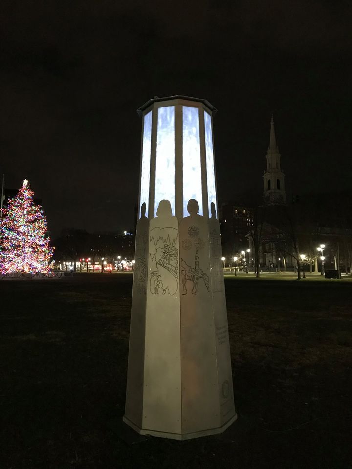 A Christmas tree stands behind the Yale Humanist Community's obelisk.