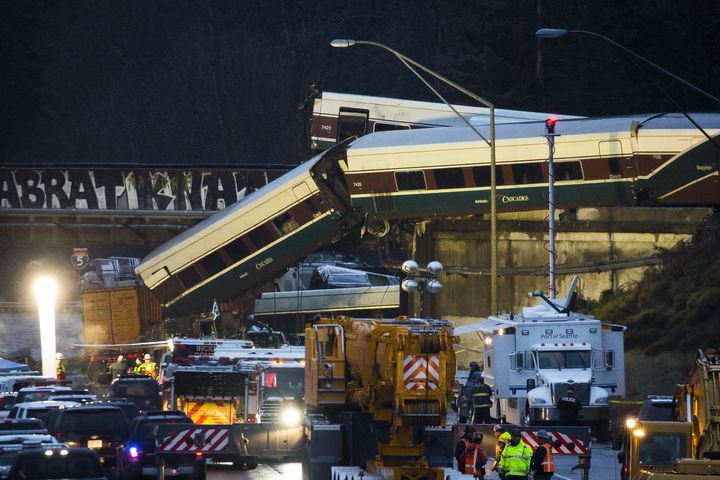 Amtrak train cars lie on Interstate 5 after a derailment in DuPont, Washington 