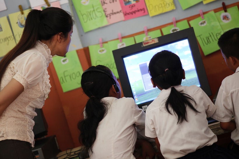 Students learning English via a computer software (location: Spean Chreav Amelio Primary School, Siem Reap, Cambodia)