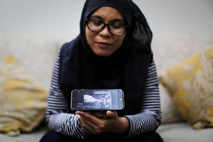 Diyana looks at a digital portrait of her late husband, Rostam Ramili.