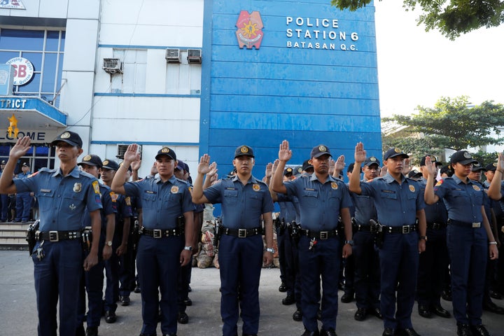 Policemen swear allegiance to the Constitution.