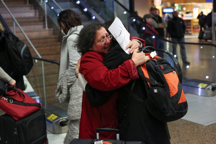 Neeta Hull (L) hugs her cousin Afsaneah Hashemi (R) following Hashemi's arrival from Iran during a pause in Trump's travel ban, Feb. 6, 2017.