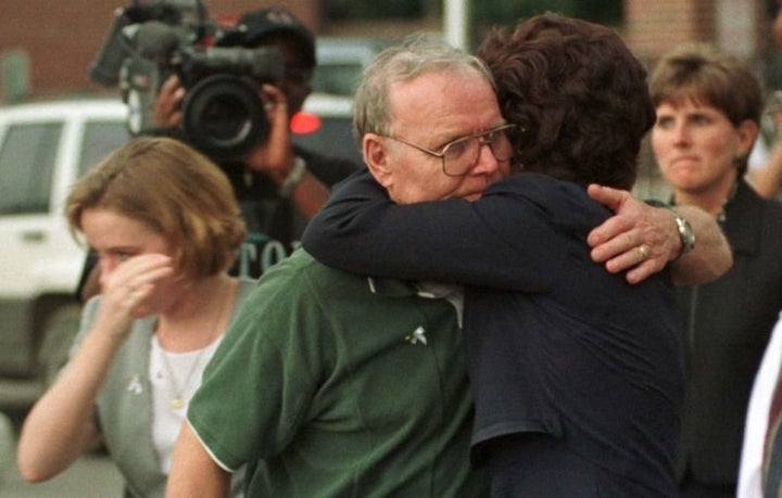 Family members of victims of the Jonesboro, Ark., school shooting embrace following the convictions of Mitchell Johnson and Andrew Golden.