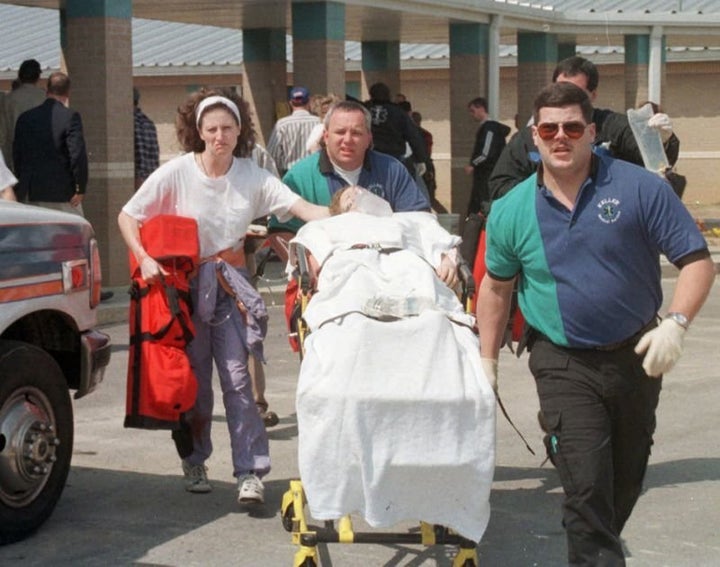 Emergency personnel rush an unidentified student to an ambulance at Westside Middle School.