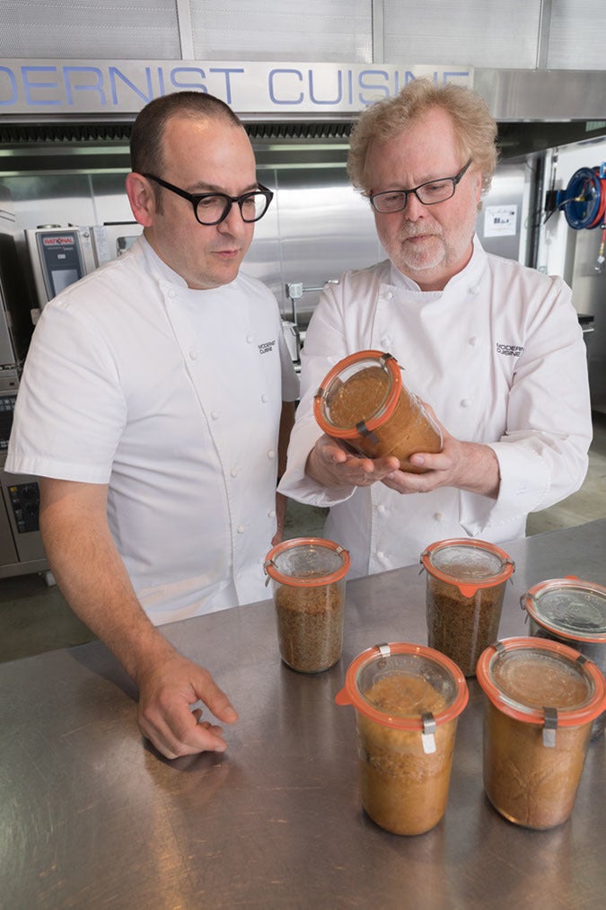 Francisco Migoya (left) and Nathan Myhrvold (right) working on <em>Modernist Bread</em> in The Cooking Lab
