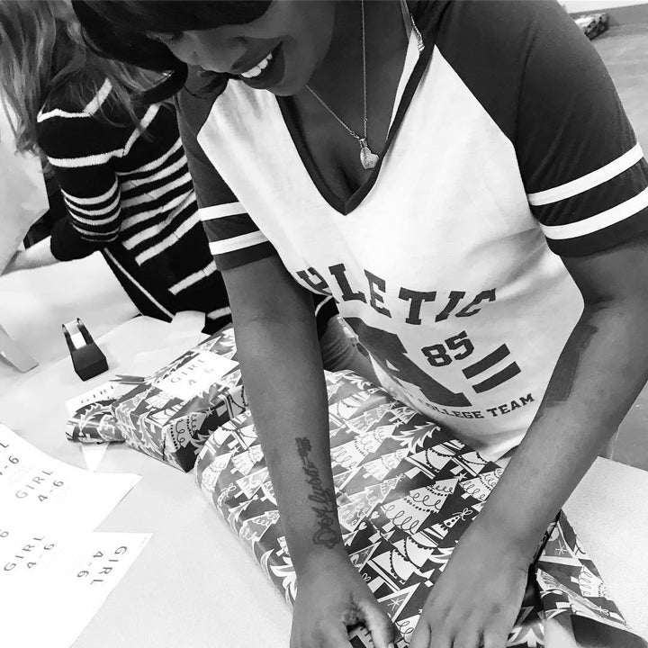 <p>Narcisse James volunteering and wrapping Christmas gifts for Sylvia Weatherspoon’s Toy Drive</p>