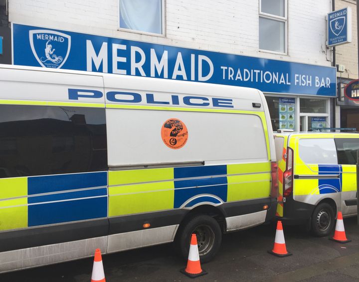 Police vans parked outside a fish and chip shop in Chesterfield 
