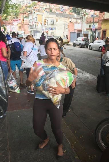 Woman Receives Subsidized Food Through CLAP Program, San Agustin