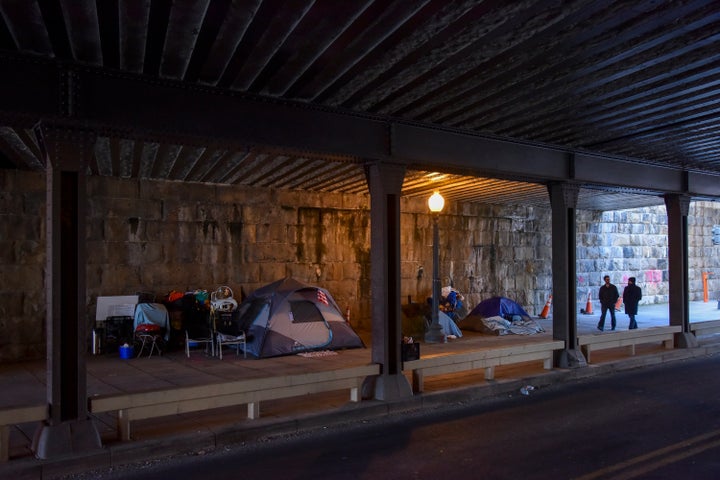 Pedestrians pass an expanding tent city under an overpass in Washington, D.C., last week.